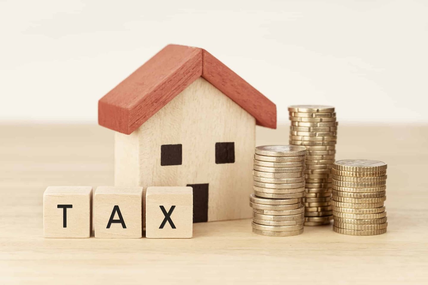 Model house beside a calculator and tax forms