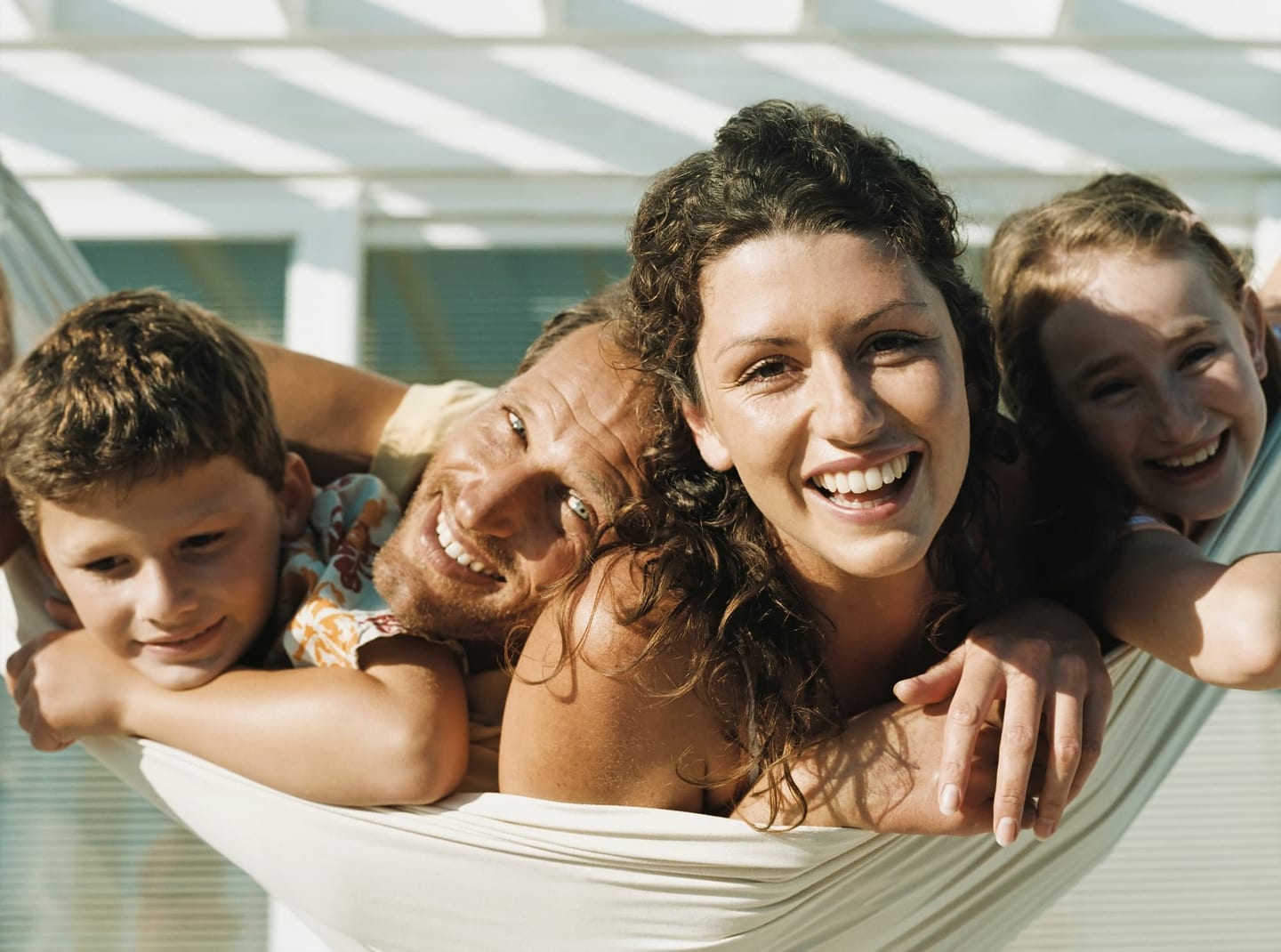 Family relaxing together in a hammock