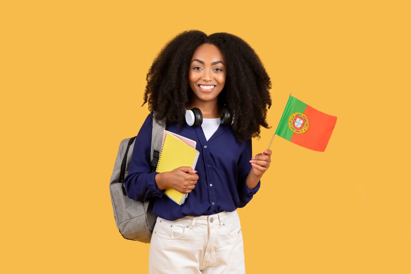 Student holding notebooks and a Portuguese flag