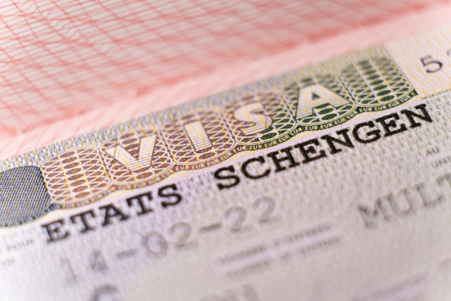 Close-up of a passport page with a Schengen residence visa sticker