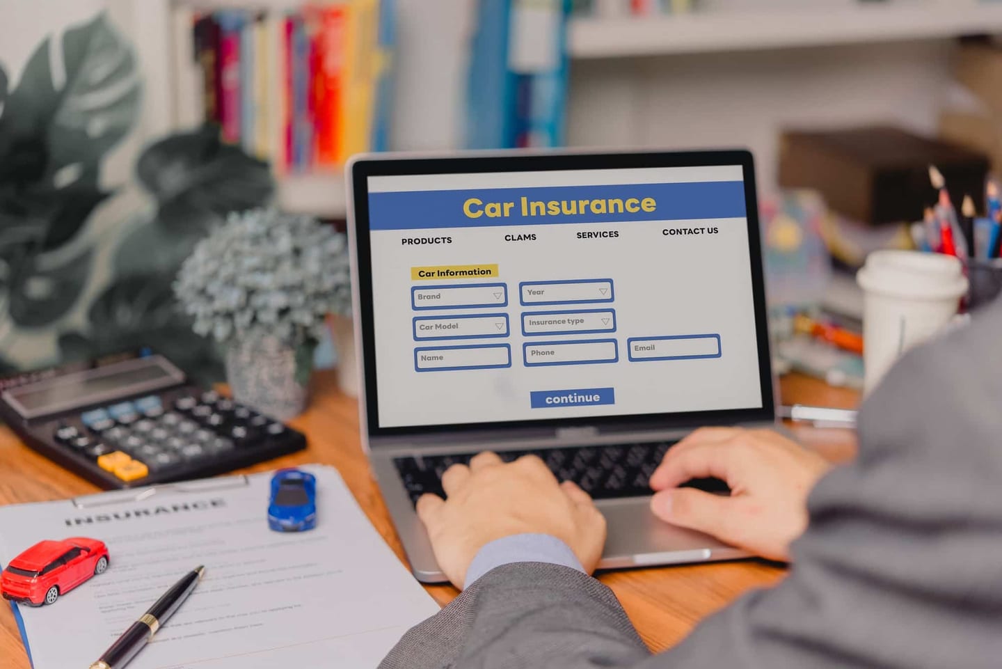 Person comparing car insurance quotes on a laptop