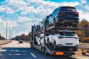 Car transport truck driving on highway road. Car Carrier Trailer on asphalt road