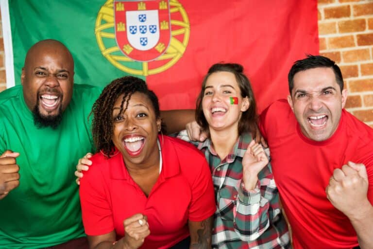 Friends cheering world cup with painted flag