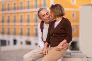 Happy Senior Couple Enjoying Time Together Embracing Sitting Outside