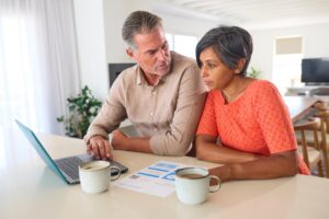 Mature Couple At Home Worried About Debt Bills And Rising Cost Of Living